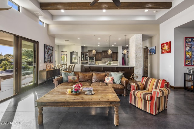 living room featuring beam ceiling, ceiling fan, and a high ceiling