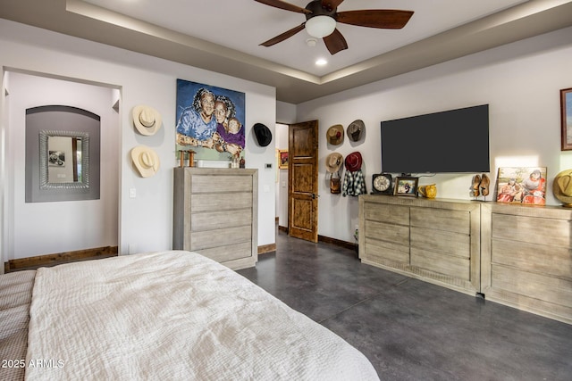 bedroom featuring ceiling fan and a tray ceiling