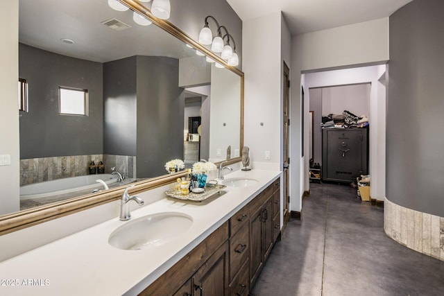 bathroom with vanity, a bath, and concrete floors