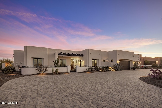 pueblo-style house with a garage