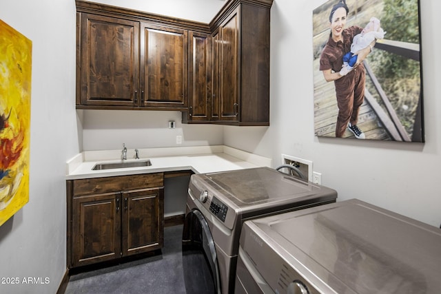 laundry area featuring cabinets, sink, and washing machine and dryer