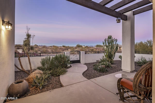 patio terrace at dusk with a pergola