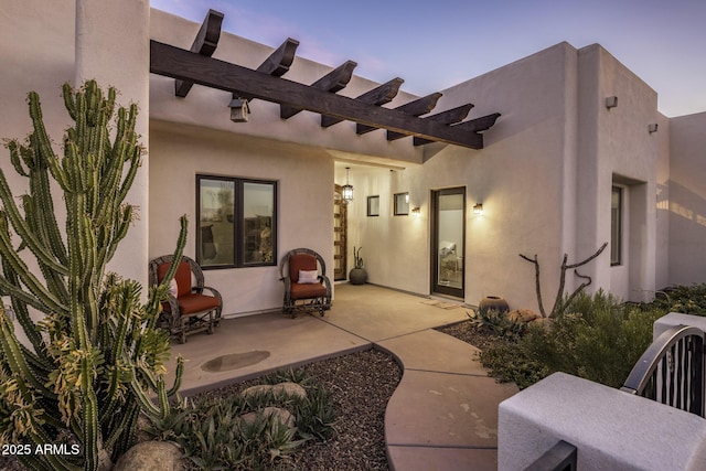 back house at dusk with a patio area