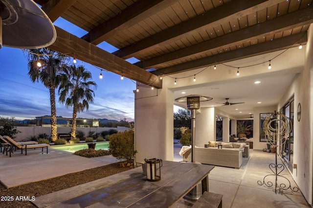 patio terrace at dusk featuring an outdoor living space, a fenced in pool, and ceiling fan