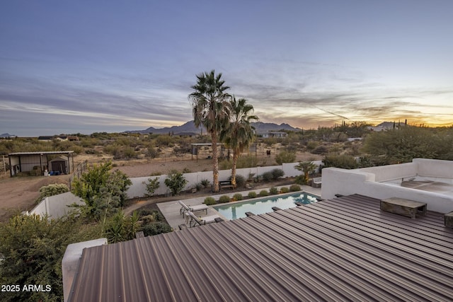 exterior space with a fenced in pool and a mountain view