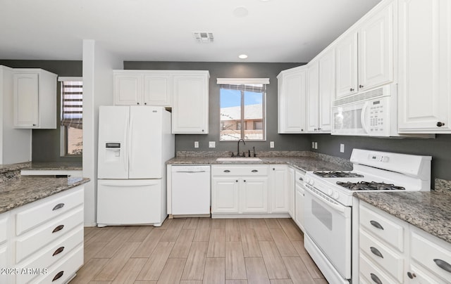 5787 W Barbara Ave, Glendale, AZ 85302 - kitchen featuring white appliances, a sink, white cabinetry, wood finish floors, and light stone counters
