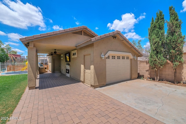 5787 W Barbara Ave, Glendale, AZ 85302 - view of front of property with a ceiling fan, stucco siding, a garage, and concrete driveway