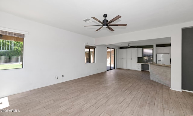 5787 W Barbara Ave, Glendale, AZ 85302 - unfurnished living room with ceiling fan, light wood-style floors, and baseboards
