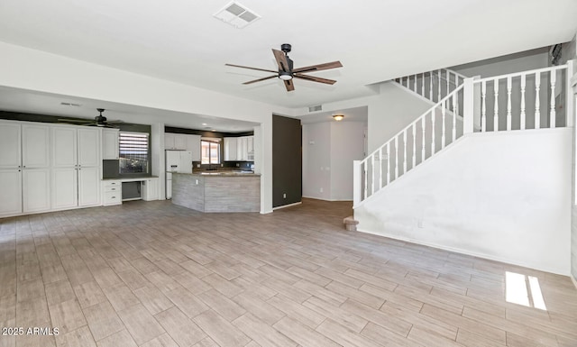 5787 W Barbara Ave, Glendale, AZ 85302 - unfurnished living room featuring a ceiling fan, stairway, and light wood-style floors