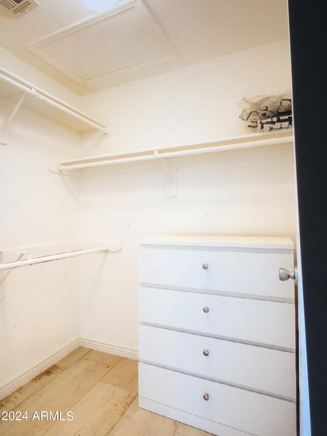 spacious closet with light hardwood / wood-style flooring