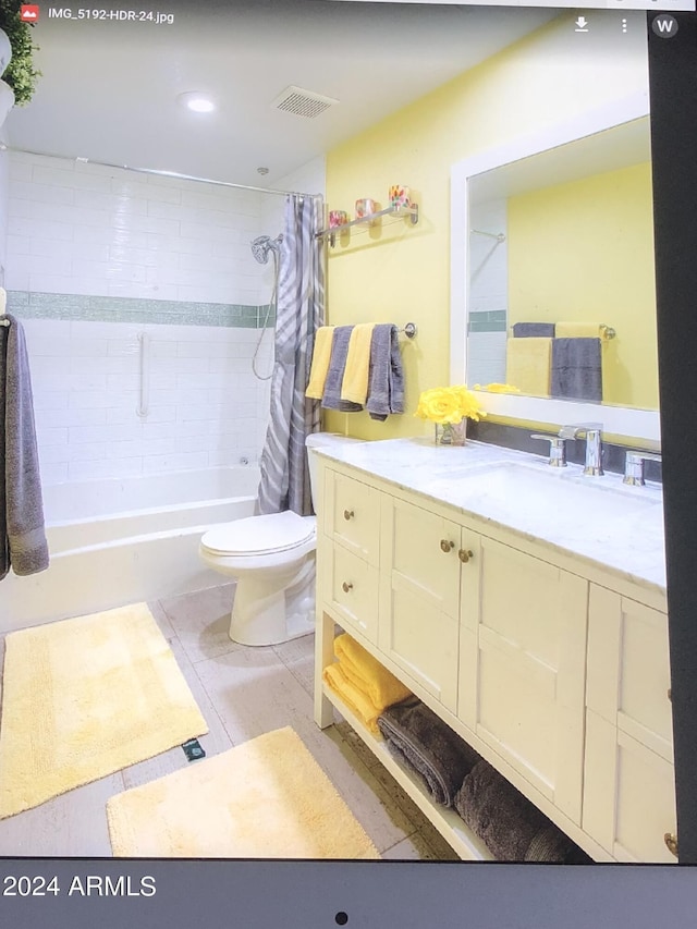 full bathroom featuring vanity, toilet, shower / bath combination with curtain, and tile patterned floors