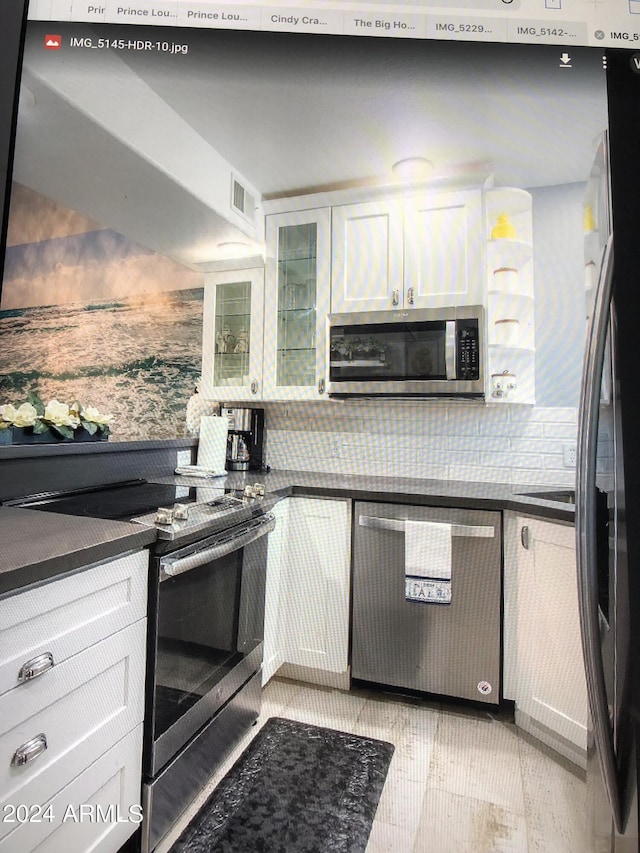 kitchen featuring white cabinets and appliances with stainless steel finishes