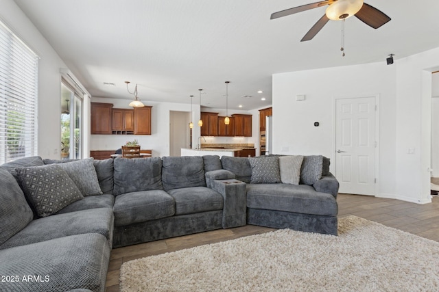 11142 E Ravenna Ave, Mesa, AZ 85212 - living area featuring light wood-type flooring, ceiling fan, recessed lighting, and baseboards