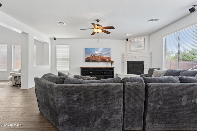 11142 E Ravenna Ave, Mesa, AZ 85212 - living room with a ceiling fan, wood finished floors, plenty of natural light, and a stone fireplace
