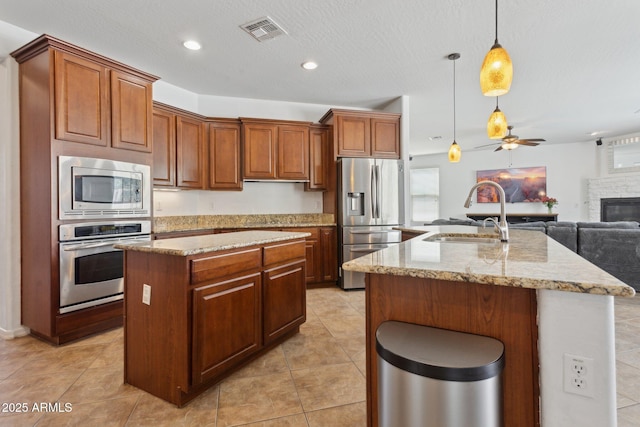 11142 E Ravenna Ave, Mesa, AZ 85212 - kitchen featuring appliances with stainless steel finishes, an island with sink, a sink, open floor plan, and recessed lighting