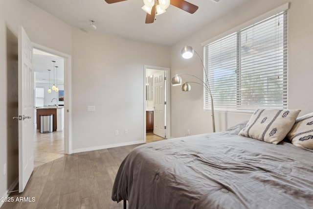11142 E Ravenna Ave, Mesa, AZ 85212 - bedroom with a sink, multiple windows, light wood-type flooring, and baseboards