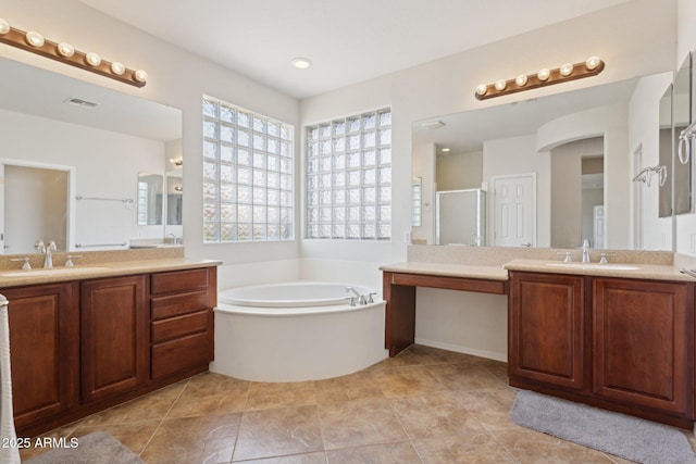 11142 E Ravenna Ave, Mesa, AZ 85212 - full bathroom with two vanities, a bath, a shower stall, and tile patterned floors