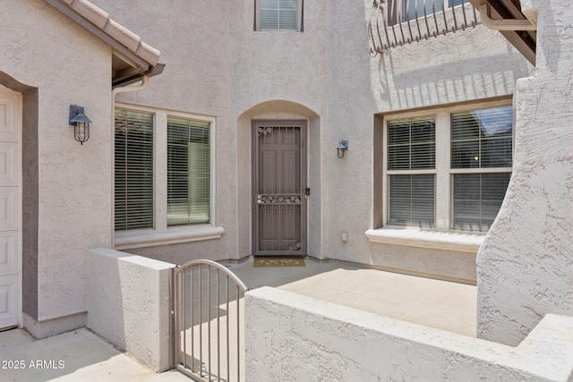 11142 E Ravenna Ave, Mesa, AZ 85212 - view of exterior entry with stucco siding and a gate