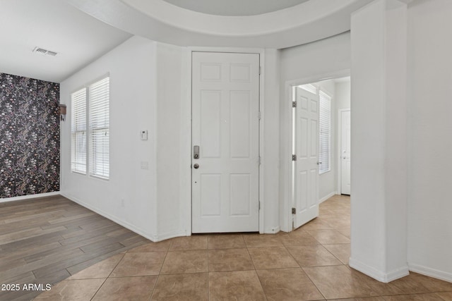 11142 E Ravenna Ave, Mesa, AZ 85212 - foyer entrance featuring wallpapered walls, baseboards, and light tile patterned floors