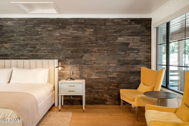 bedroom with hardwood / wood-style floors and ornamental molding