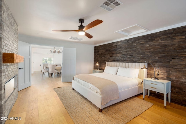 bedroom with ceiling fan with notable chandelier, light hardwood / wood-style floors, and crown molding