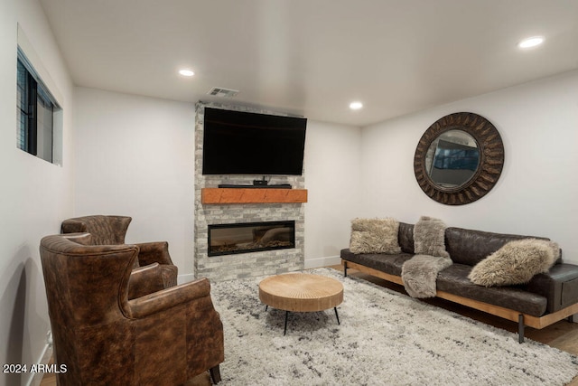 living room with hardwood / wood-style floors and a fireplace