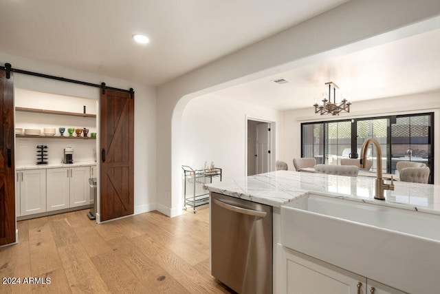 kitchen with white cabinetry, light wood-type flooring, a notable chandelier, sink, and dishwasher