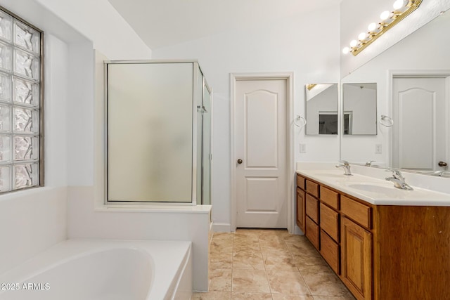 bathroom featuring tile patterned flooring, shower with separate bathtub, vanity, and lofted ceiling