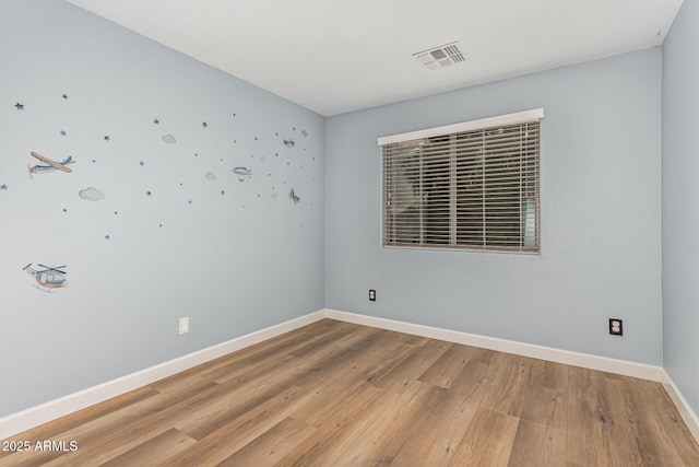 spare room featuring hardwood / wood-style floors