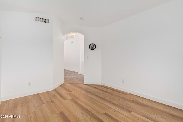 unfurnished room featuring hardwood / wood-style flooring
