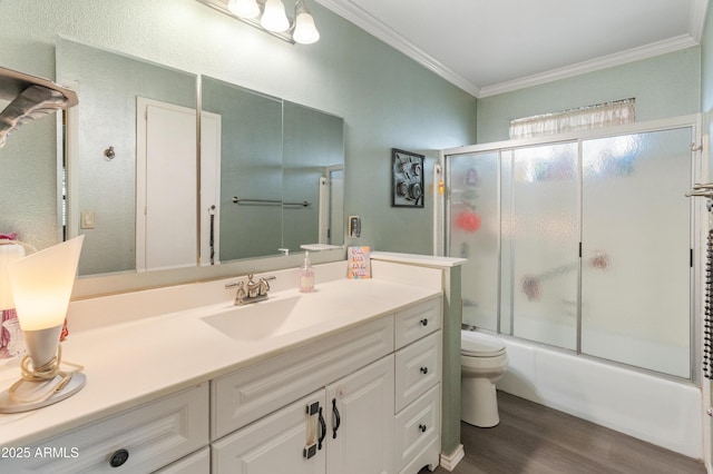 10228 W Concord Ave, Sun City, AZ 85351 - full bathroom with toilet, ornamental molding, wood finished floors, vanity, and enclosed tub / shower combo