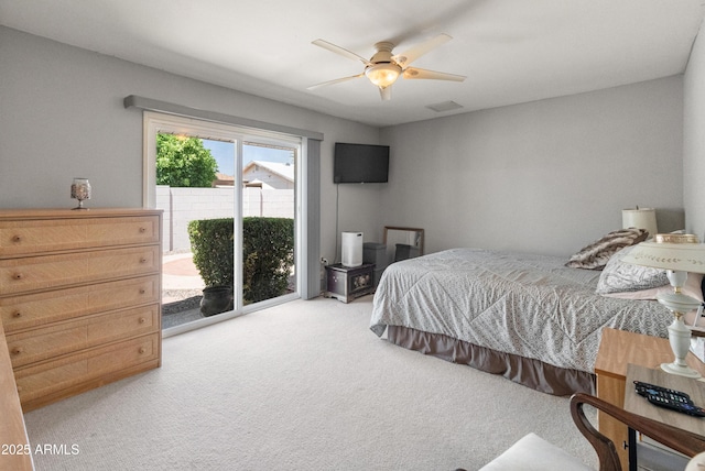 10228 W Concord Ave, Sun City, AZ 85351 - bedroom with access to outside, light carpet, and a ceiling fan