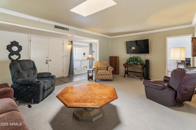 10228 W Concord Ave, Sun City, AZ 85351 - living room featuring a skylight, ornamental molding, and light colored carpet