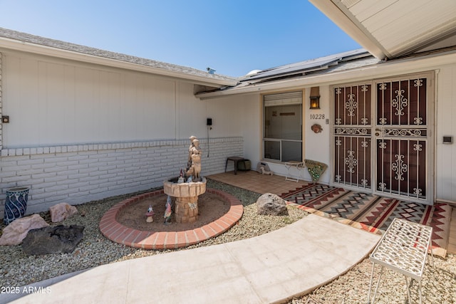 10228 W Concord Ave, Sun City, AZ 85351 - view of exterior entry featuring solar panels and a porch