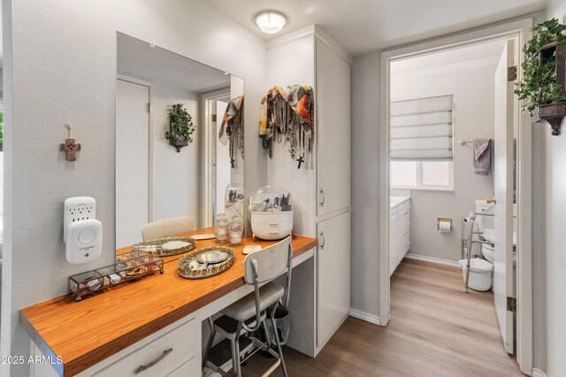 10228 W Concord Ave, Sun City, AZ 85351 - bathroom with wood finished floors, baseboards, and vanity