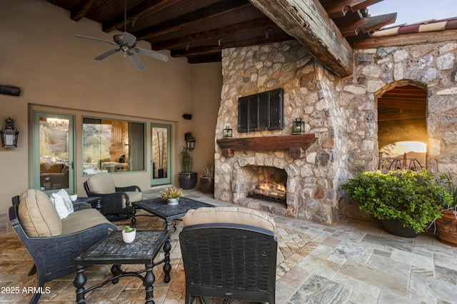 view of patio / terrace featuring an outdoor living space with a fireplace and ceiling fan