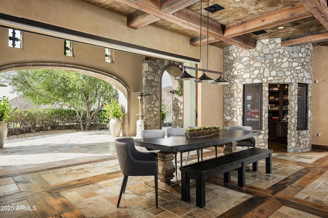 dining area with beamed ceiling