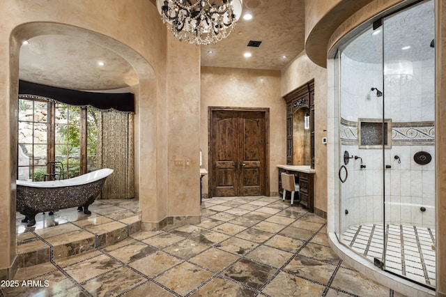 bathroom featuring french doors, independent shower and bath, and an inviting chandelier