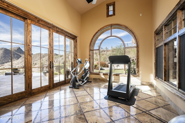 workout area with a mountain view, french doors, and a towering ceiling