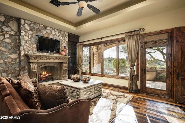 living room featuring hardwood / wood-style floors, ceiling fan, a healthy amount of sunlight, and a fireplace