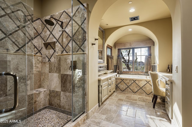 bathroom featuring vanity and shower with separate bathtub