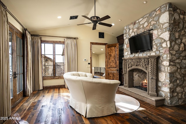 living room with a fireplace, dark hardwood / wood-style floors, vaulted ceiling, and ceiling fan