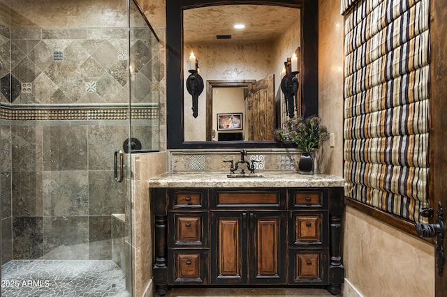 bathroom featuring vanity and a shower with shower door