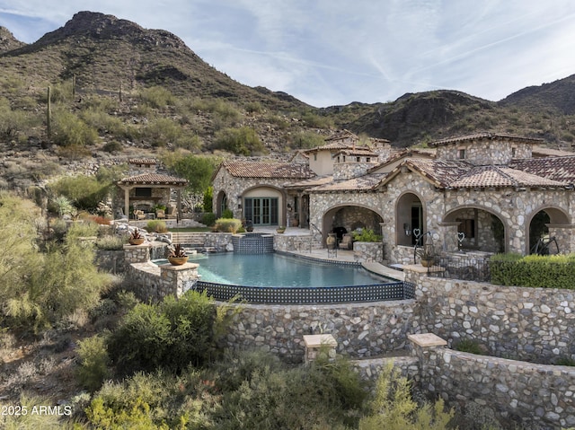 view of pool with a mountain view and a patio