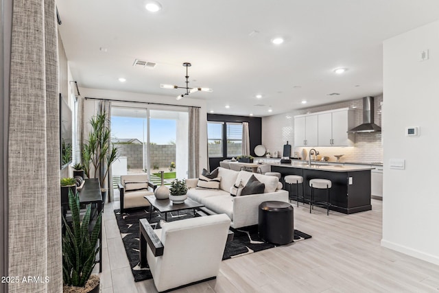 living room featuring light hardwood / wood-style floors and sink