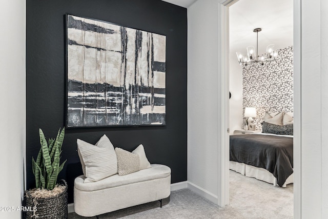 sitting room with a chandelier and carpet floors