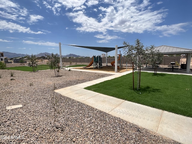 view of playground featuring a mountain view, a gazebo, and a yard