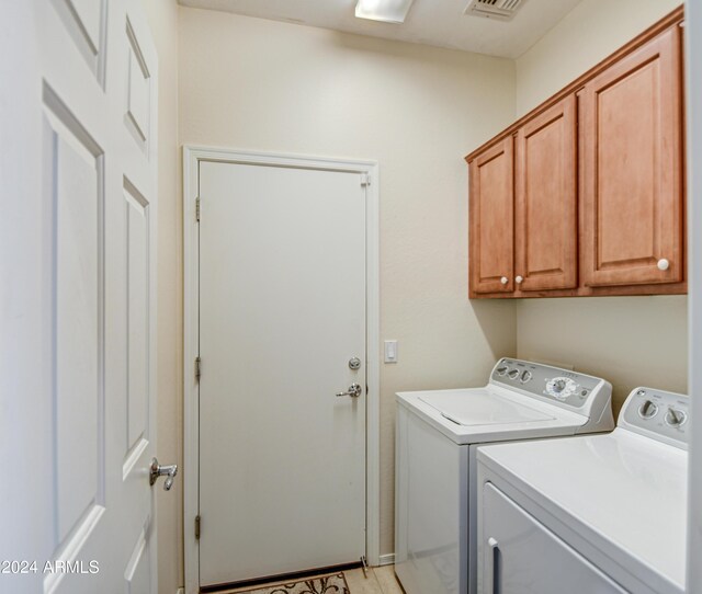 bathroom featuring a shower with shower door, dual bowl vanity, and tile patterned floors