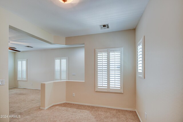 carpeted empty room featuring ceiling fan