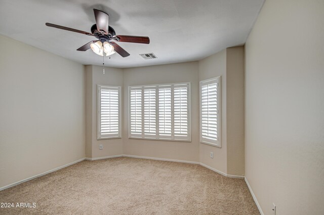 kitchen featuring ceiling fan, black appliances, light colored carpet, light stone countertops, and sink